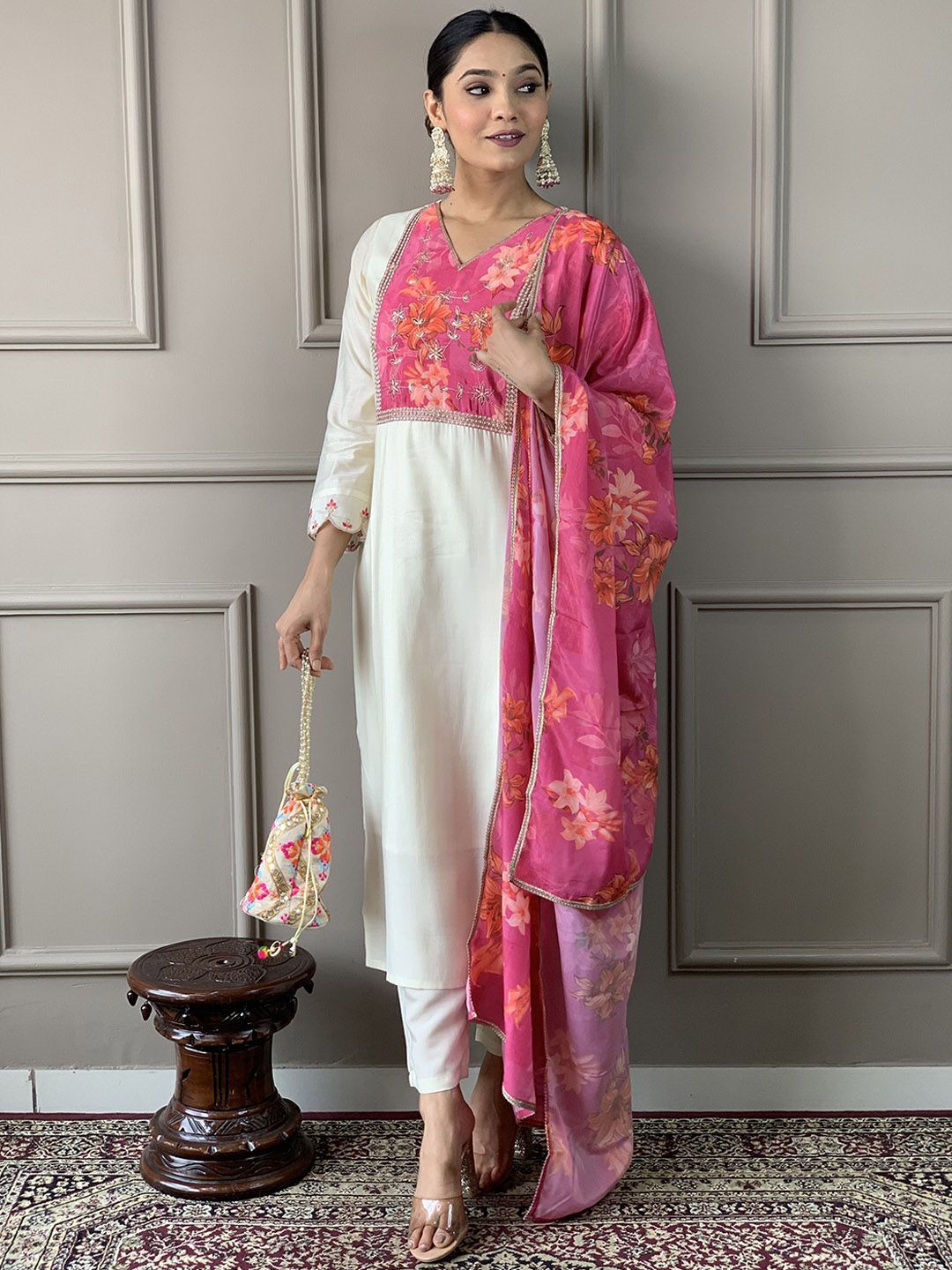 A white straight-cut kurta with pink floral embroidery on the Kurta and Pant set